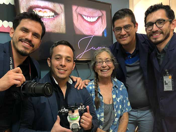 The patient and the All on 6 doctors smile after a successful treatment.