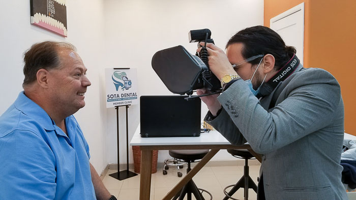 The fixed denture doctor is taking a photo to the patient in Mexico.