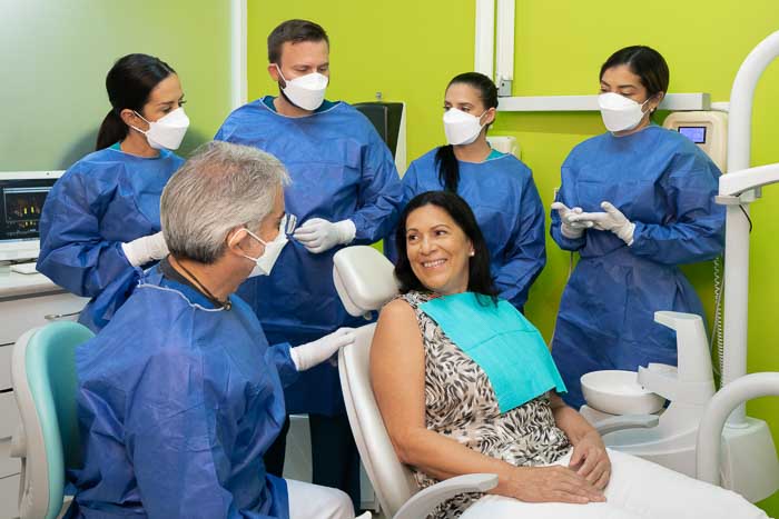 Happy patient with doctors in Mexico before a snap on treatment.