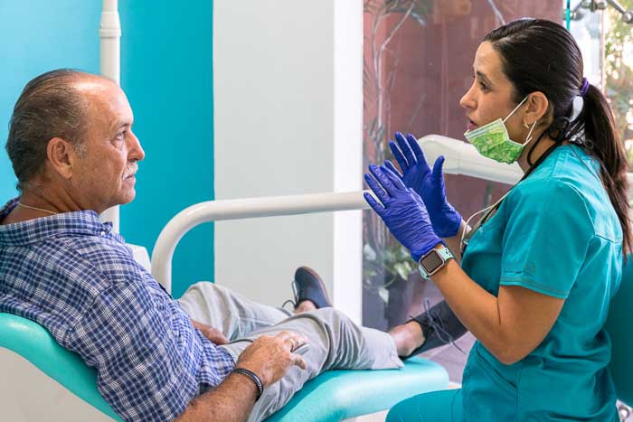 Snap On Dentures doctor talking to the patient at a clinic in Mexico.